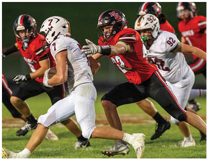 A football player in a white jersey running on the field. Description generated by AI