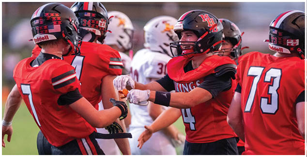 A group of football players wearing red and white uniforms. Description generated by AI