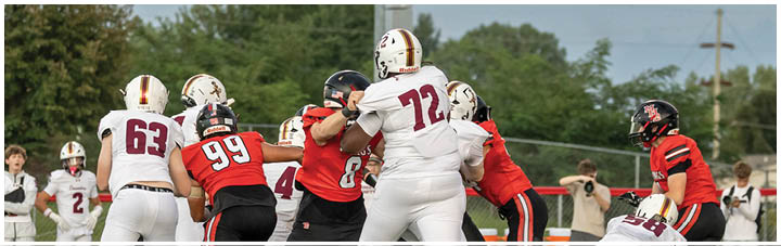 A group of football players on the field. Description generated by AI