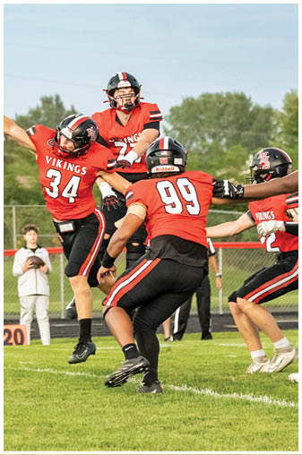 A football game is taking place with players on the field. Description generated by AI
