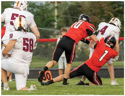 A football player is sliding into the end zone. Description generated by AI