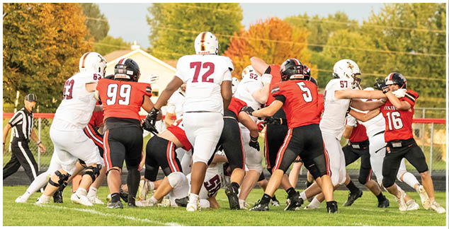 A group of football players on a field. Description generated by AI