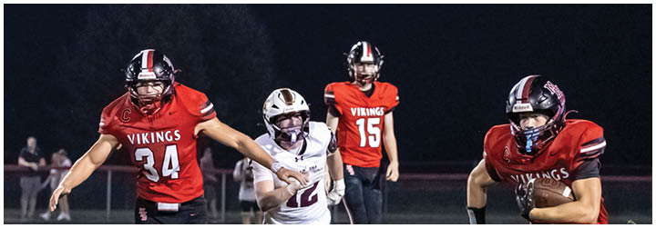 A football player running with the ball. Description generated by AI
