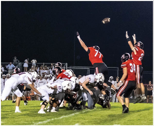 A football player catching a ball. Description generated by AI