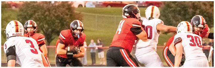 A football game is taking place with players in red and white uniforms. Description generated by AI