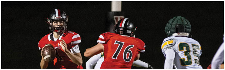 A football player wearing a red jersey with the number 16. Description generated by AI