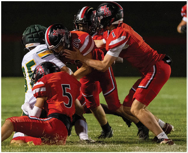 A group of football players on the field. Description generated by AI