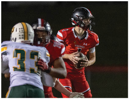 A football player in a red jersey with the number 32 on it. Description generated by AI