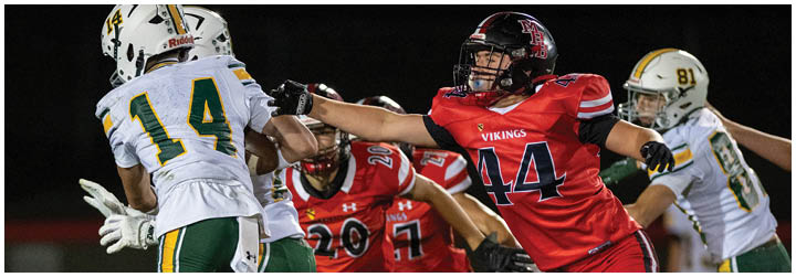 A football player wearing a red jersey with the number 41 on it. Description generated by AI