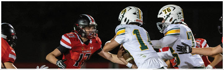 A football game is being played with players wearing red and white uniforms. Description generated by AI