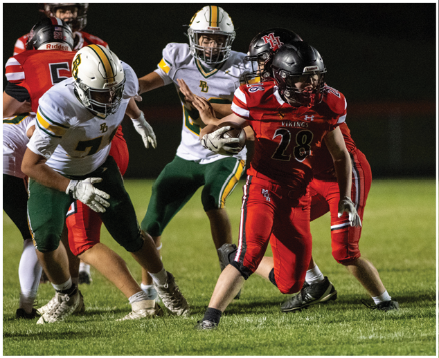 A football player in a red jersey is running with the ball. Description generated by AI