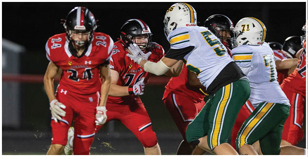 A football player in a red jersey running on the field. Description generated by AI