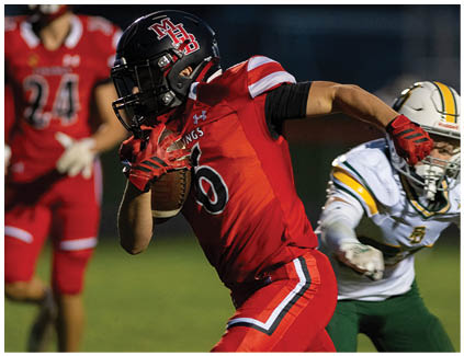 A football player in a red jersey with the number 9 on it. Description generated by AI