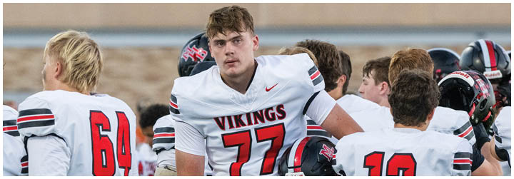 A group of football players wearing red and white uniforms. Description generated by AI