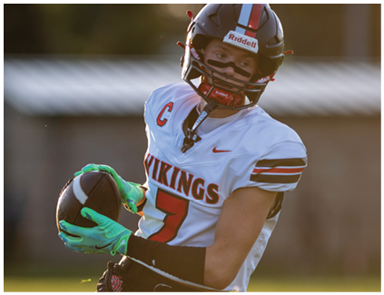 A football player wearing a white and black jersey with the number 7 on it. Description generated by AI