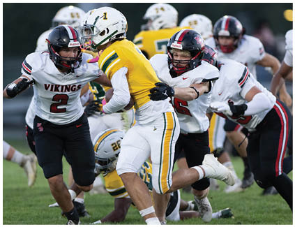 A football player wearing a yellow and green jersey. Description generated by AI