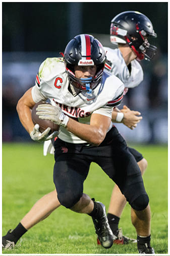 A football player in a black jersey with the number 6 on it. Description generated by AI