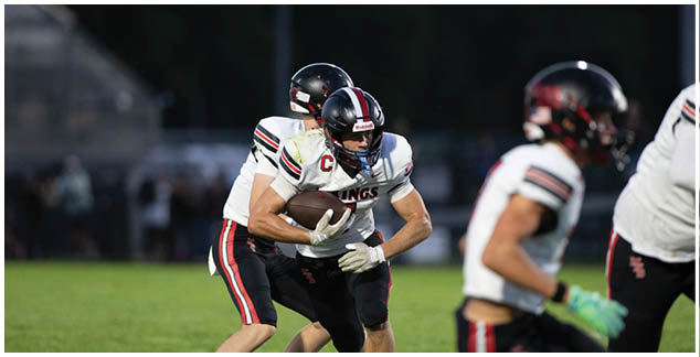 A football player in a white jersey with the number 4 on it. Description generated by AI