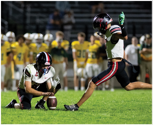 A man is kicking a football. Description generated by AI