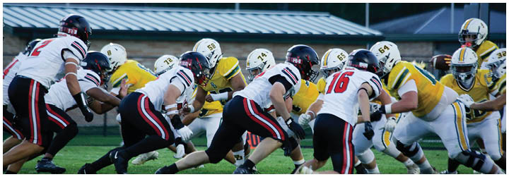 A group of football players in a field. Description generated by AI