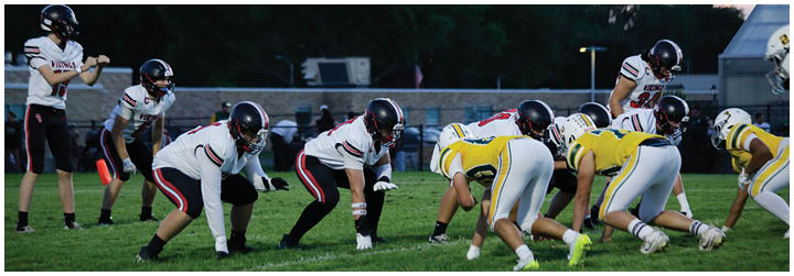 A group of football players in a field. Description generated by AI