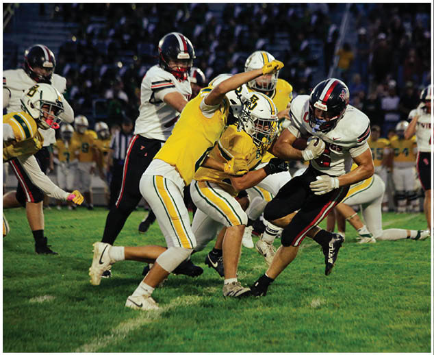 A group of football players on a field. Description generated by AI