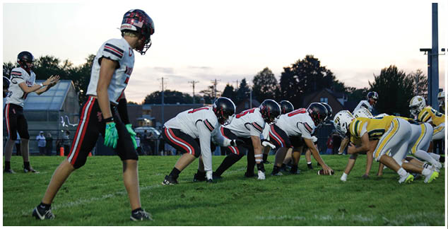 A group of football players are on the field. Description generated by AI