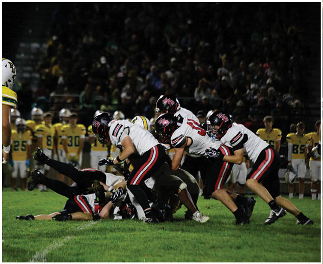 A group of football players on a field. Description generated by AI
