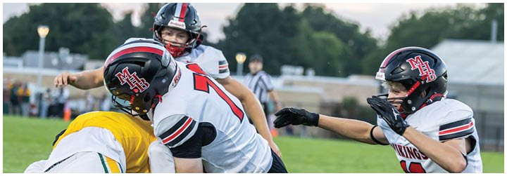 A football player in a white jersey with the number 11 on it. Description generated by AI