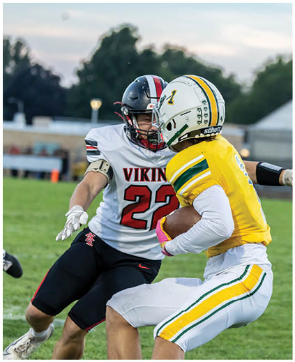 A football player in a white jersey with the number 22 on it. Description generated by AI