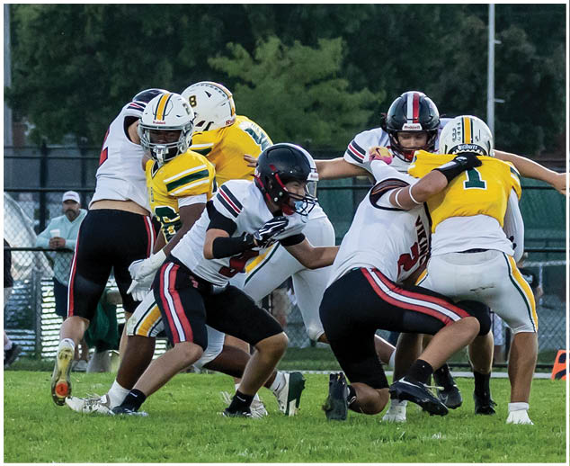 A group of football players on a field. Description generated by AI