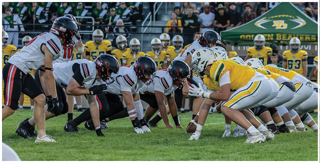 A group of football players in a field. Description generated by AI