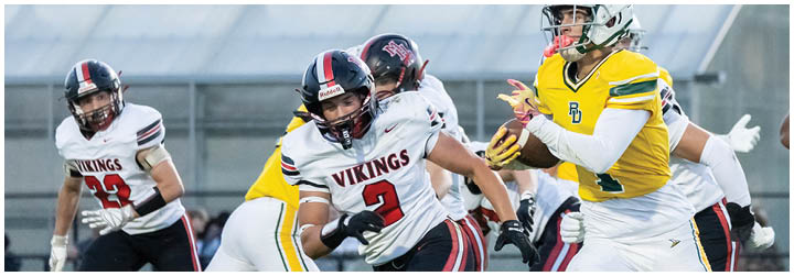 A football player in a yellow jersey is running with the ball. Description generated by AI