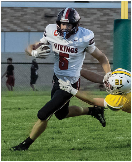 A football player is running with the ball. Description generated by AI