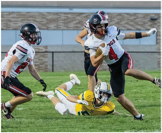 A football player in a yellow jersey is sliding on the ground. Description generated by AI