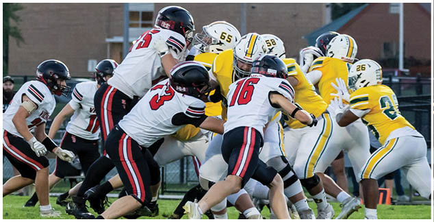 A group of football players on a field. Description generated by AI