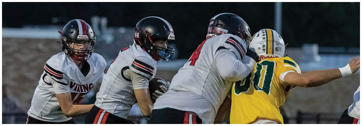A group of football players on a field. Description generated by AI