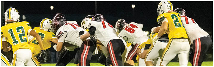 A group of football players in a huddle. Description generated by AI