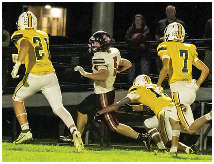 A group of football players on a field. Description generated by AI