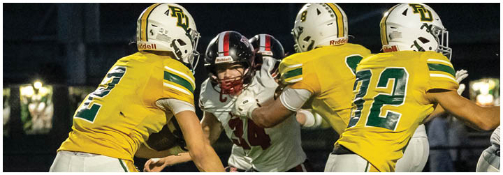 A group of football players in a game. Description generated by AI