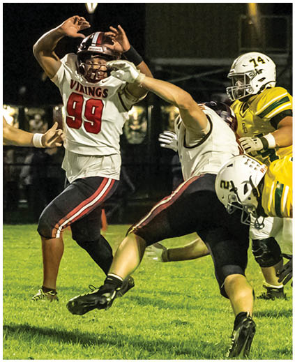 A football player in a white jersey with the number 90 on it. Description generated by AI
