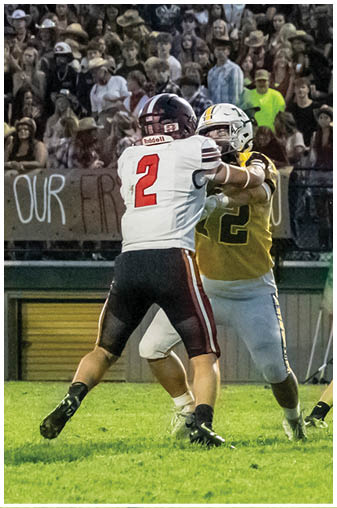 Two football players on a field. Description generated by AI