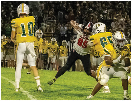 A football player in a yellow jersey is running with the ball. Description generated by AI