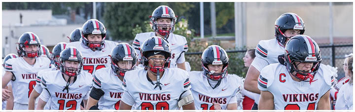 A group of football players wearing black and white uniforms. Description generated by AI