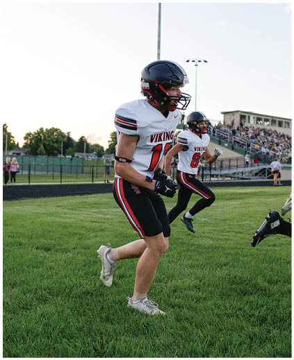 A football player running on the field. Description generated by AI