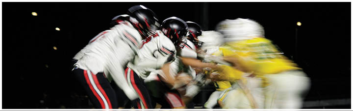 A group of football players in a game. Description generated by AI