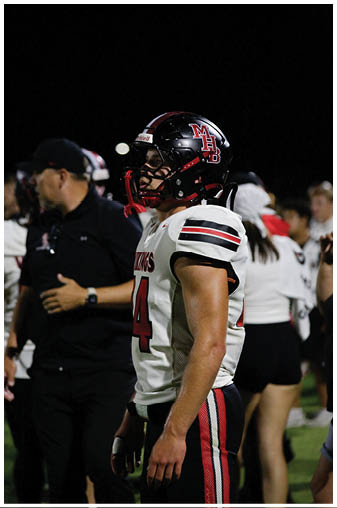 A football player wearing a helmet and jersey with the number 44. Description generated by AI