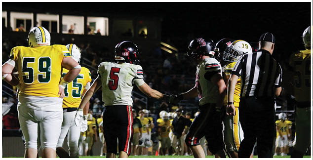 A group of football players on a field. Description generated by AI