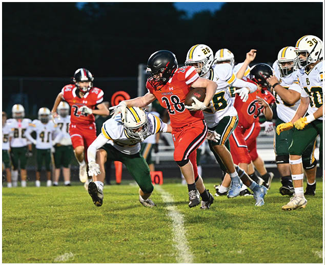 A group of football players on a field. Description generated by AI