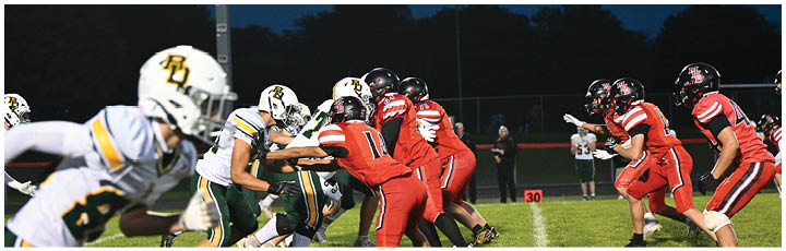 A football game is taking place on a field. Description generated by AI